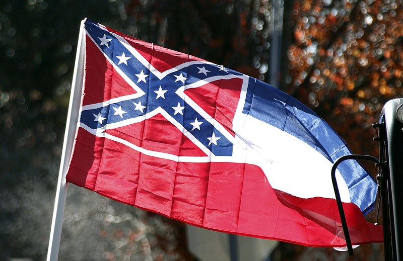 
              FILE - In this Tuesday, Jan. 19, 2016 file photo, a Mississippi state flag is unfurled by Sons of Confederate Veterans and other groups on the grounds of the state Capitol in Jackson, Miss., in support of keeping the Confederate battle emblem on the state flag. A black Mississippi citizen is taking his case against the state’s Confederate-themed flag to the U.S. Supreme Court. In papers filed Wednesday, June 28, 2017, attorneys for Carlos Moore said lower courts were wrong to reject his argument that the flag is a symbol of white supremacy that harms him and his young daughter by violating the Constitution’s guarantee of equal protection to all citizens. (AP Photo/Rogelio V. Solis, File)
            