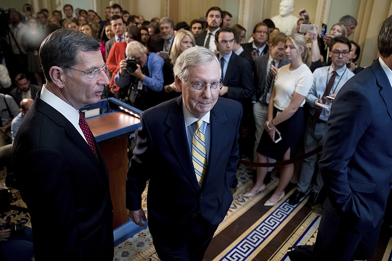
              Senate Majority Leader Mitch McConnell, R-Ky., joined by Sen. John Barrasso, R-Wyo., left, departs after announcing that he is delaying a vote on the Republican health care bill while the GOP leadership works toward getting enough votes, at the Capitol in Washington, Tuesday, June 27, 2017. (AP Photo/Andrew Harnik)
            