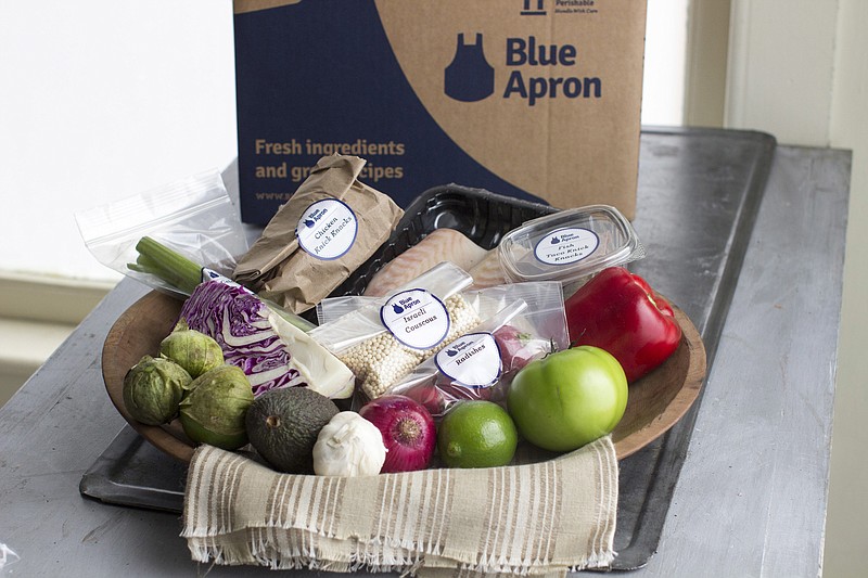 
              FILE - This Oct. 6, 2014, file photo shows an example of a home delivered meal from Blue Apron, in Concord, N.H. On Wednesday, June 28, 2017, Blue Apron, the meal-kit delivery company, slashed the price it expects to sell its shares by as much as 40 percent, a sign that the company may be having trouble attracting investors. (AP Photo/Matthew Mead, File)
            