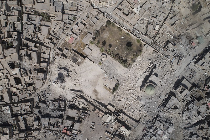 
              FILE - This Wednesday, June 28, 2017 file photo shows an aerial view of the destroyed al-Nuri mosque during fighting between Iraqi security forces and Islamic State militants in the Old City of Mosul, Iraq. Al-Nuri was a symbol of Mosul because of its minaret. For centuries, it was the tallest minaret in Iraq, nearly 60 meters (yards) high, cylindrical and decorated with elaborated interlaced brickwork. But what made it most unique and beloved was that it leaned precariously. That earned it the nickname “al-Hadbaa,” Arabic for “the Hunchback.” (AP Photo/Felipe Dana, File)
            