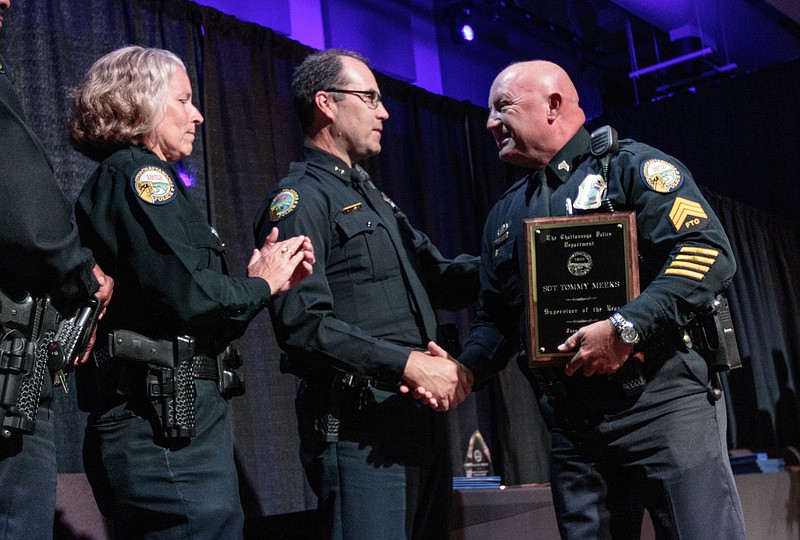 Supervisor of the year recipient Sgt. Tommy Meeks, right, is congratulated by assistant chiefs Eric Tucker, center, and Danna Vaughn at the Chattanooga Police Department's annual awards ceremony held at Calvary Chapel church on Thursday, June 29, 2017, in Chattanooga, Tenn. The annual ceremony honors officers, community partners, and federal law enforcement partners of the CPD for exceptional public service.