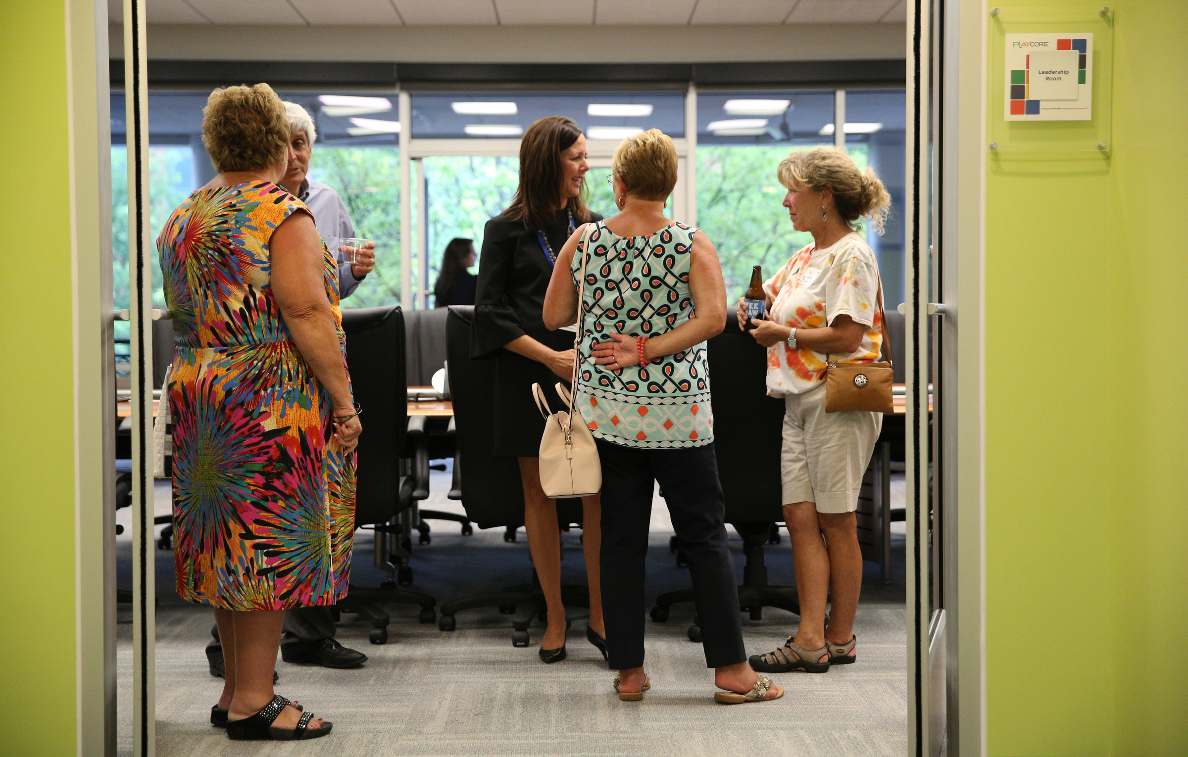Jane Kaylor with the Ronald McDonald House, Henry Schulson with the Creative Discovery Museum, Lisa Moore, senior vice president at PlayCore, Diane Parks with the Chamber of Commerce and Pam Hudson with Signal Centers talk while touring one of the meeting rooms Thursday, June 29, 2017, during PlayCore's grand opening event in Chattanooga, Tenn. PlayCore is a Chattanooga-based and the nationճ largest maker of playground equipment.