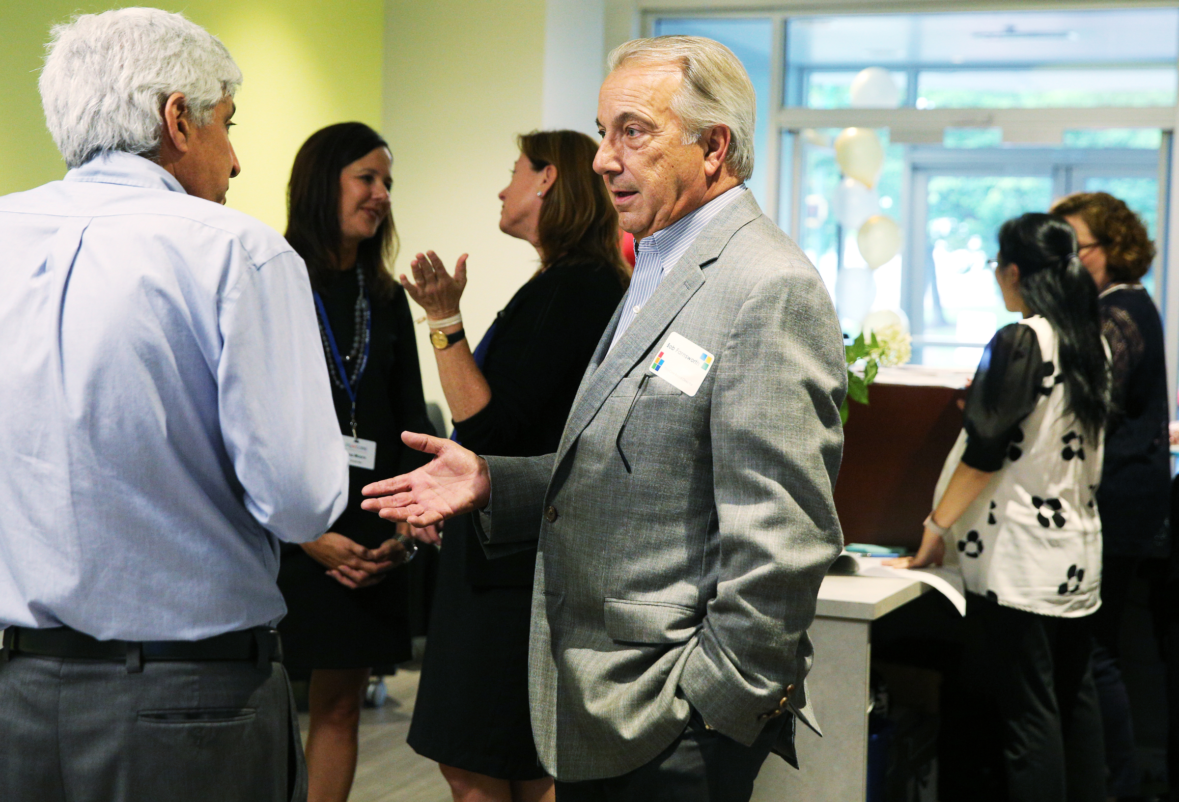 Henry Schulson, executive director of the Creative Discovery Museum, speaks with Bob Farnsworth, the retired CEO of PlayCore, Thursday, June 29, 2017, during PlayCore's grand opening event in Chattanooga, Tenn. The company originally had seven employees in its corporate office when it was founded 19 years ago and now has more than 100.