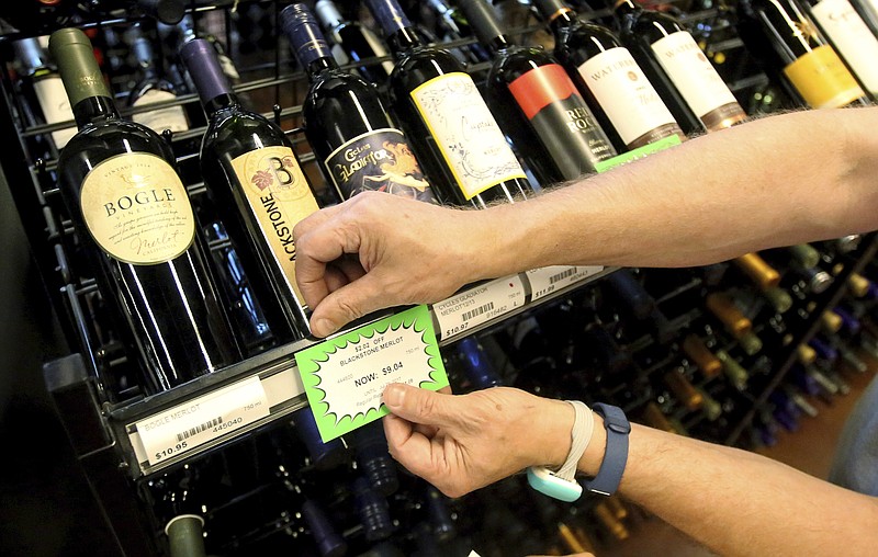 
              A worker at a state liquor store changes prices on wine, liquor and higher-alcohol beer, after closing to the public Friday, June 30, 2017, near downtown Salt Lake City. Higher liquor prices and other changes under a broad new Utah liquor law will take effect Saturday, along with a highway funding bill and a test program allowing people convicted of drunken driving to avoid having their driver's license suspended. (AP Photo/Rick Bowmer)
            