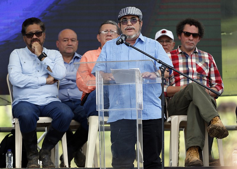 
              FILE - In this June, 27, 2017 file photo, Rodrigo Londono, also known as Timoleon Jimenez or Timochenko, the top commander of the Revolutionary Armed Forces of Colombia, FARC, gives his speech during an act to commemorate the completion of the disarmament process of FARC rebels, in Buenavista, Colombia. On Sunday, July 2, 2017, Timochenko was hospitalized with stroke, and remains in intensive care in Colombia. (AP Photo/Fernando Vergara, File)
            