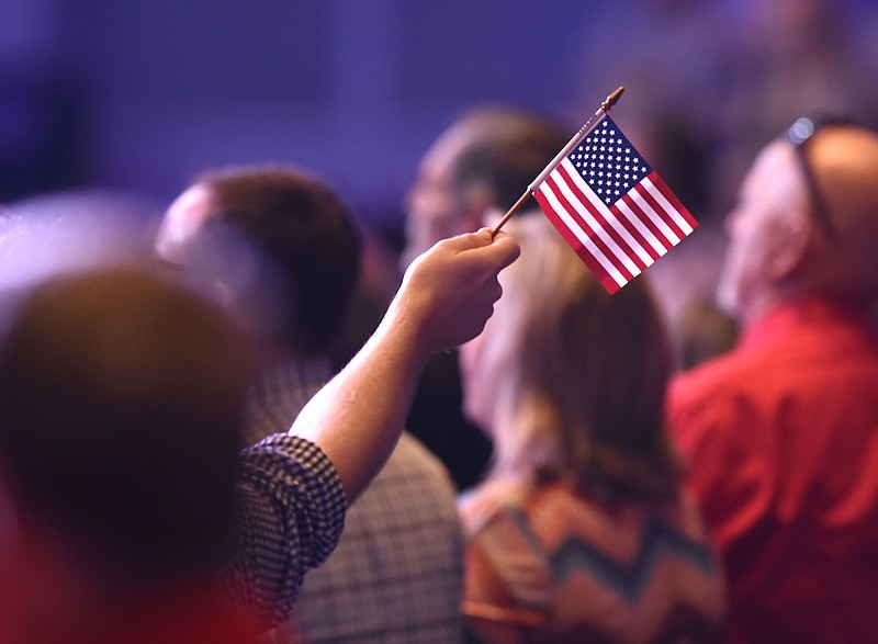 A small American Flag is waved during the service.  Former Pastor and Governor of Arkansas Mike Huckabee spoke at Abba's House, in Hixson, on All American Day on July 2, 2017.  