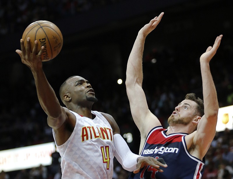 
              In this April 28, 2017, photo, Atlanta Hawks forward Paul Millsap (4) shoots against Washington Wizards forward Jason Smith (14) in the first half of an NBA playoff basketball game in Atlanta. A person with knowledge of the situation told The Associated Press on Sunday, July 2, that Paul Millsap has agreed to terms with the Denver Nuggets on a three-year deal worth $90 million. The person spoke on condition of anonymity because the contract cannot be signed until Thursday. (AP Photo/John Bazemore)
            
