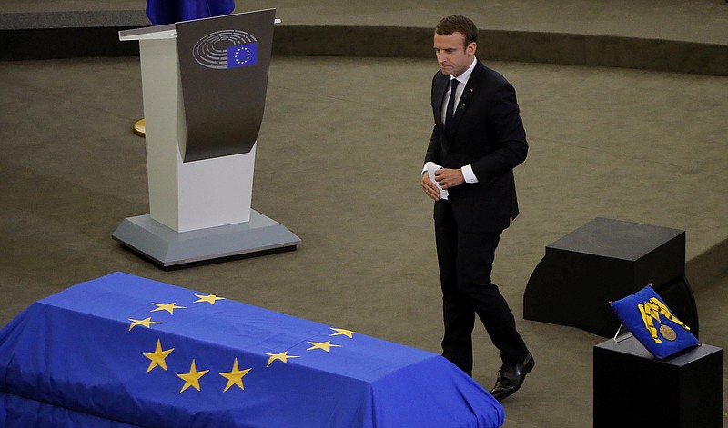 
              French President Emmanuel Macron walks pas Helmut Kohl's coffin during an homage ceremony for former German Chancellor Helmut Kohl, at the European Parliament in Strasbourg, eastern France, Saturday July 1, 2017. Current and former leaders from Europe and beyond are gathering in Strasbourg, France to bid farewell to former German Chancellor Helmut Kohl, who died June 16 at 87. (AP Photo/Michel Euler)
            