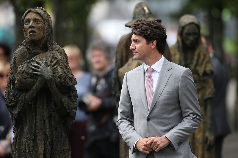 
              Canadian Prime Minister, Justin Trudeau, views the Famine Memorial statues in Dublin, after meeting with Irish Taoiseach, Leo Varadkar, Tuesday July 4, 2017. The Canadian PM has several other engagements in Dublin including a meeting with President Michael D. Higgins,  and a state dinner hosted by the Taoiseach. (Niall Carson/PA via AP)
            