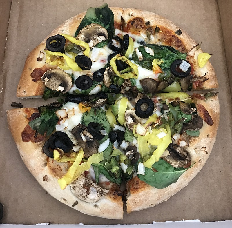 Reggie the Veggie is piled high with fresh bell peppers, spinach, banana peppers, black olives, mushrooms and diced onions.