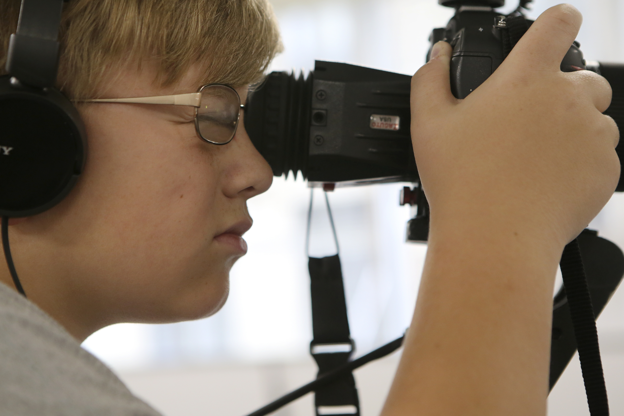 Seth Vickers, 12, works a camera as a fellow camper is interviewed by the Times Free Press during Tech Town camp at the Edeny Building on Thursday, June 29, in Chattanooga, Tenn.