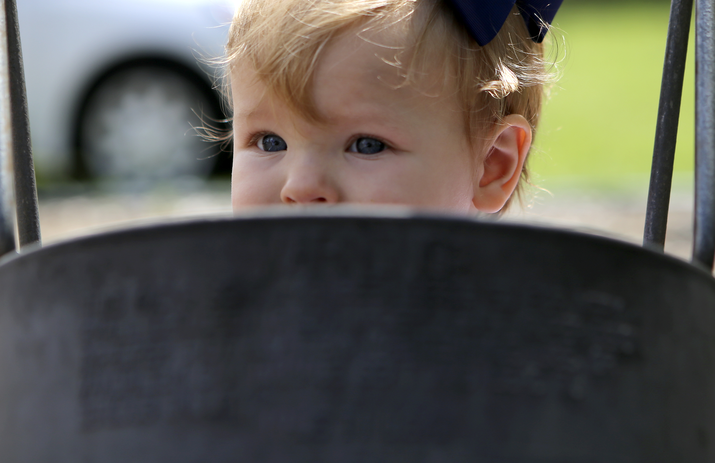 One-year-old Eloise Thrasher plays on a swing during the Signal Mountain Lions Club's annual Fourth of July barbecue at Althaus Park on Tuesday, July 4, in Signal Mountain, Tenn. According to club president Gary Lowder, 1,000 pounds of pork was cooked in preparation to serve about 700 patrons.