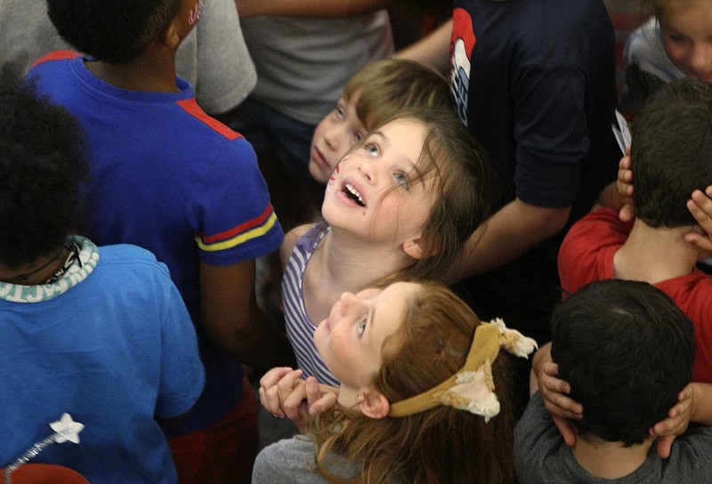 Six-year-old Audrey Bischoff looks up toward where the balloons were to fall during Red, White and Blue Day at the Creative Discovery Museum on Tuesday, July 4, in Chattanooga, Tenn. The Creative Discovery Museum held their Red, White and Blue Day which included several activities like bubblewrap fireworks, a balloon drop, birthday cake and a history lesson.