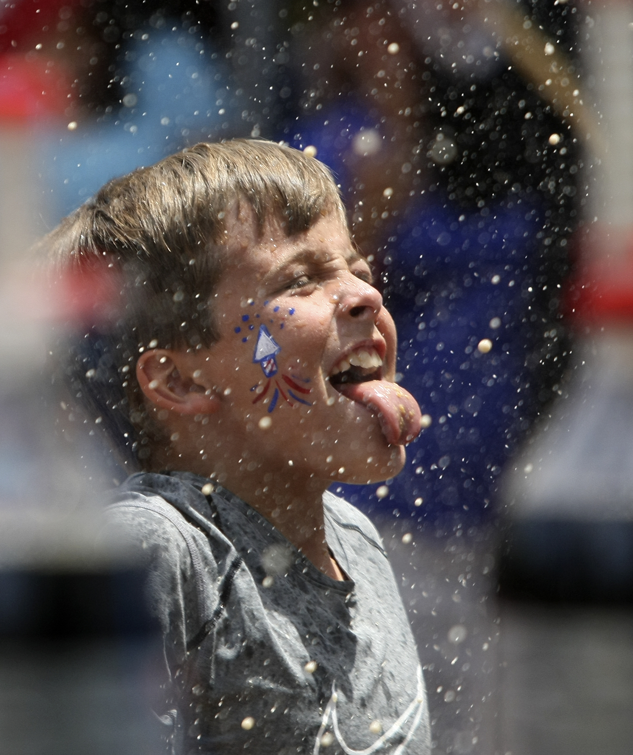 Ten-year-old Will Walker sticks his tongue out as the 21-bottle Diet Coke-and-Mentos salute goes off during Red, White and Blue Day at the Creative Discovery Museum on Tuesday, July 4, in Chattanooga, Tenn. The Creative Discovery Museum held their Red, White and Blue Day which included several activities like bubblewrap fireworks, a balloon drop, birthday cake and a history lesson.