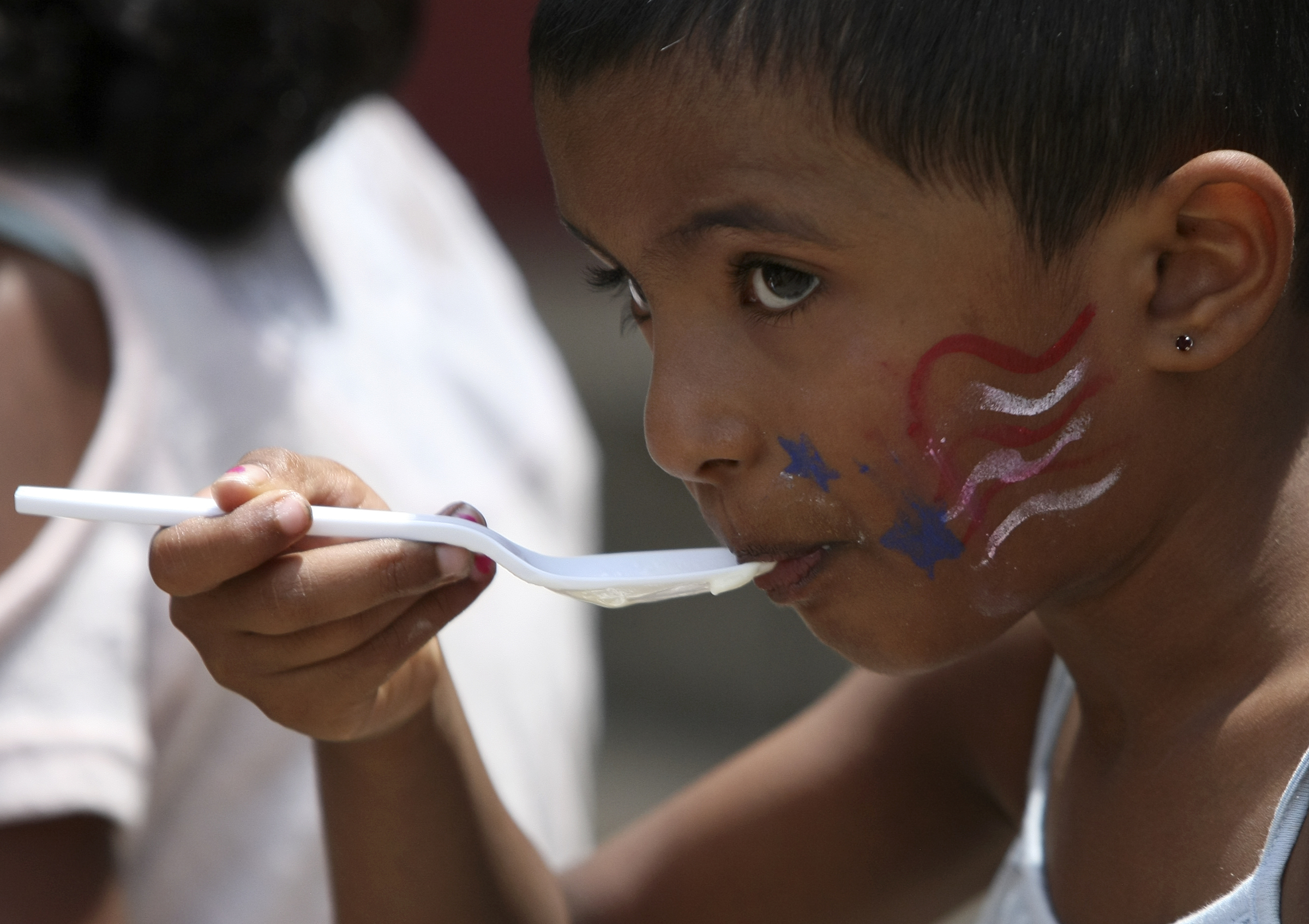 Four-year-old Meetali Patil {CQ} eats ice cream during Red, White and Blue Day at the Creative Discovery Museum on Tuesday, July 4, in Chattanooga, Tenn. The Creative Discovery Museum held their Red, White and Blue Day which included several activities like bubblewrap fireworks, a balloon drop, birthday cake and a history lesson.