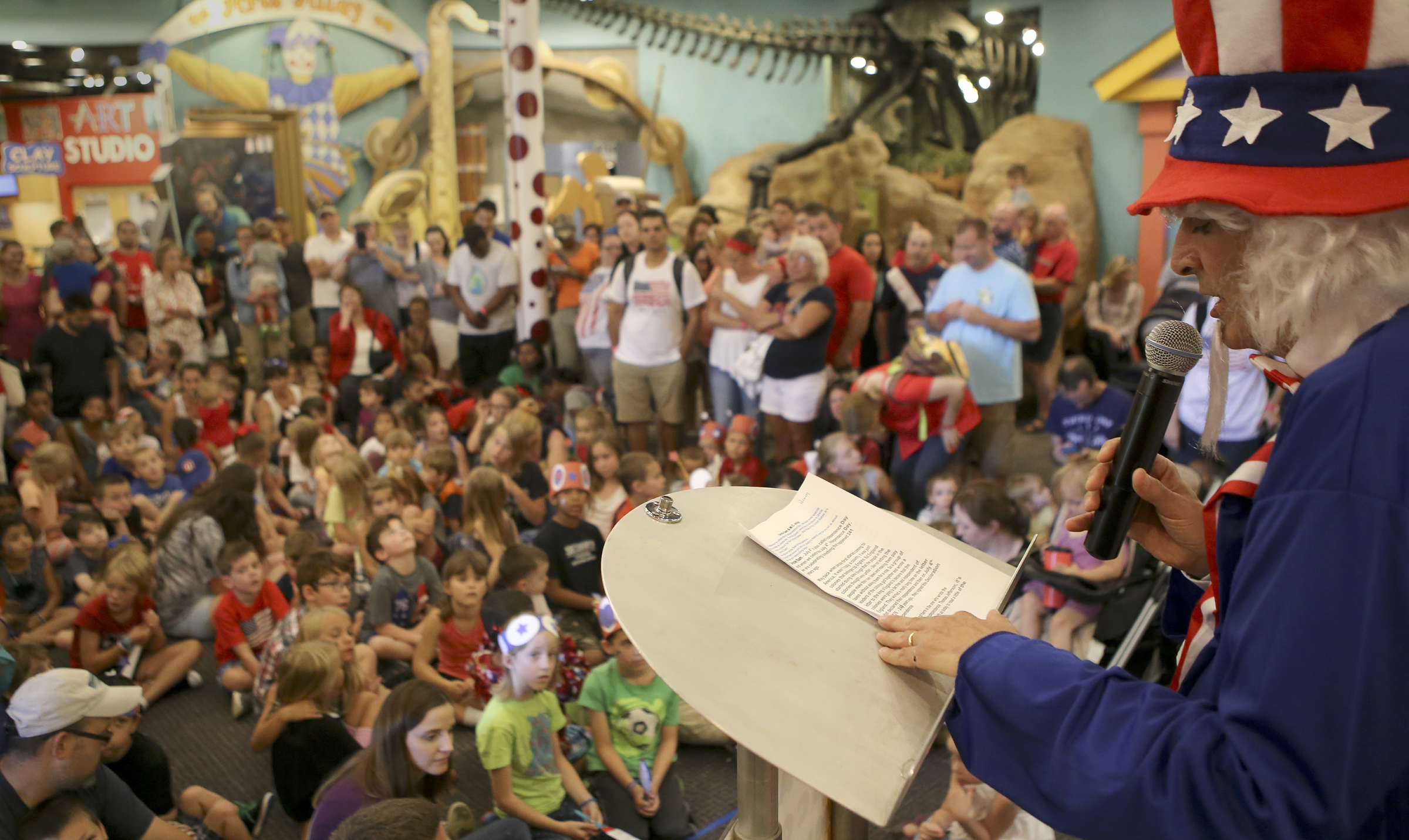 Creative Discovery Museum Executive Director Henry Schulson addresses the crowd gathered in the atrium during Red, White and Blue Day at the museum on Tuesday, July 4, in Chattanooga, Tenn. The Creative Discovery Museum held their Red, White and Blue Day which included several activities like bubblewrap fireworks, a balloon drop, birthday cake and a history lesson.