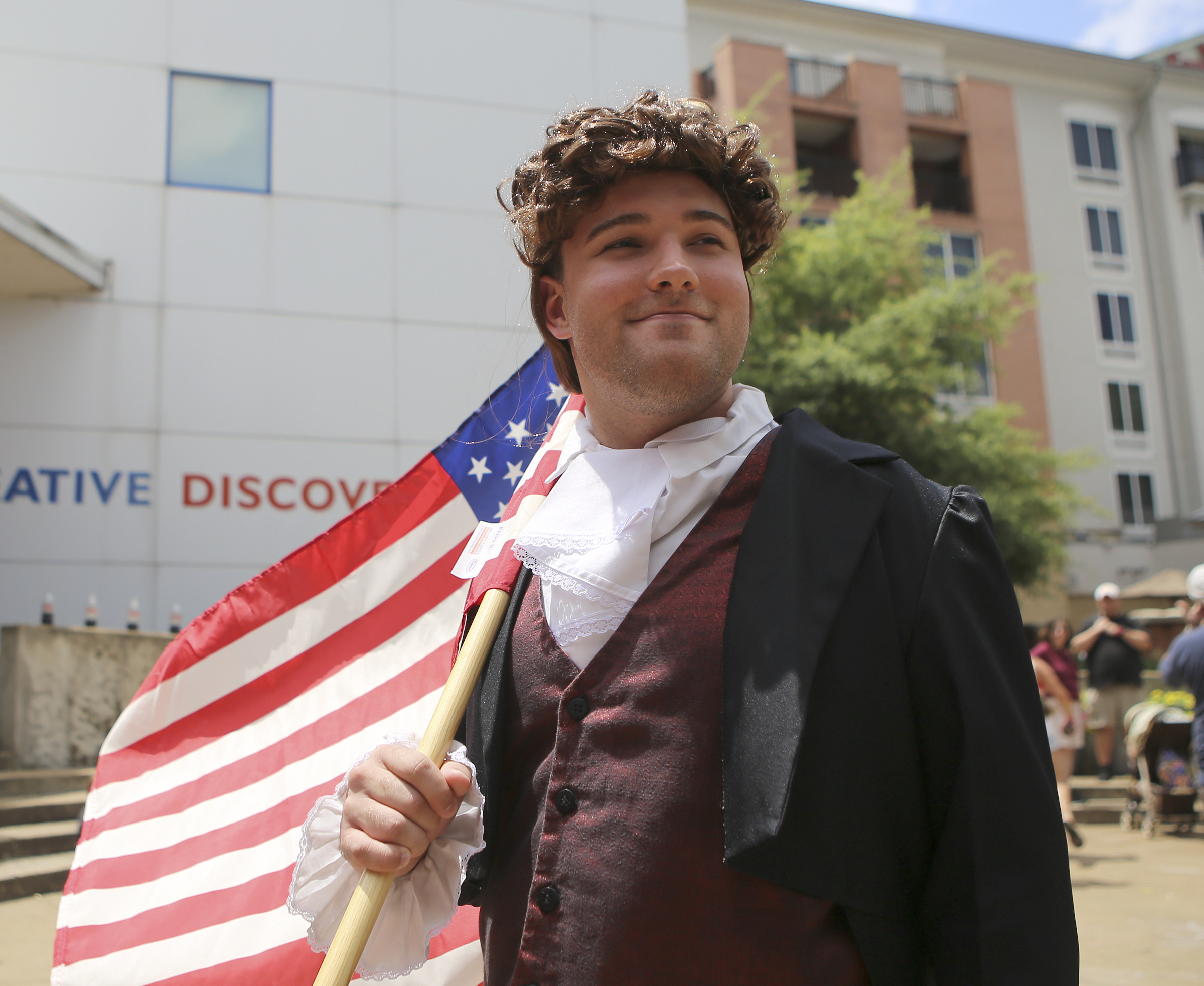 Dressed as Thomas Jefferson, Museum Educator Dean Hodge holds an American flag outside of the Creative Discovery Museum as the outdoor Red, White and Blue Day activities wind down on Tuesday, July 4, in Chattanooga, Tenn. The Creative Discovery Museum held their Red, White and Blue Day which included several activities like bubblewrap fireworks, a balloon drop, birthday cake and a history lesson.
