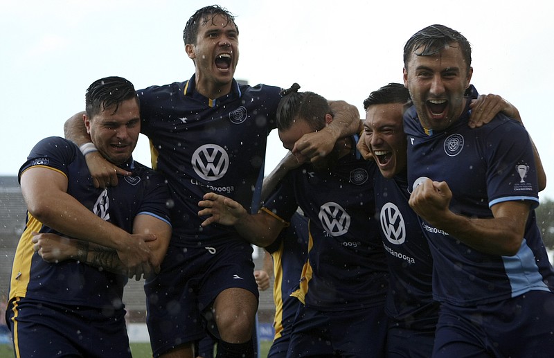 Members of Chattanooga FC celebrate after John Carrier's first-minute goal against Georgia Revolution at Finley Stadium on Tuesday, July 4, in Chattanooga, Tenn.