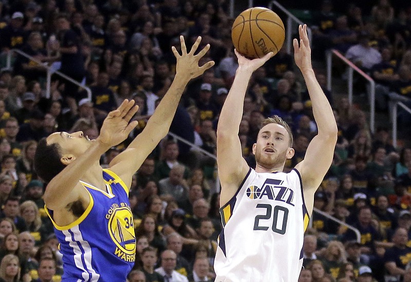 
              FILE - In this May 6, 2017, file photo, Utah Jazz forward Gordon Hayward (20) shoots as Golden State Warriors guard Shaun Livingston (34) defends in the second half during Game 3 of the NBA basketball second-round playoff series in Salt Lake City. Hayward has chosen to sign with the Boston Celtics and reunite with coach Brad Stevens, making the announcement Tuesday evening, July 4, on The Players' Tribune site. (AP Photo/Rick Bowmer, File)
            