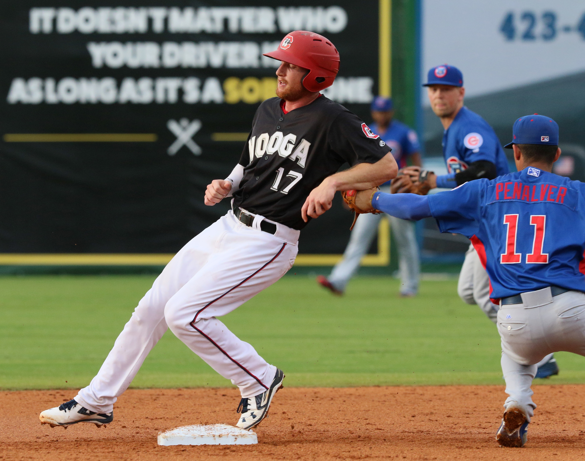 Chattanooga's Travis Harrison (17) safely makes it to second as Tennessee Smokies shortstop Carlos Penalver (11) attempts to tag him out during the Chattanooga Lookouts' game against the Tennessee Smokies Wednesday, July 5, 2017, in Southern League baseball at AT&T Field in Chattanooga, Tenn.