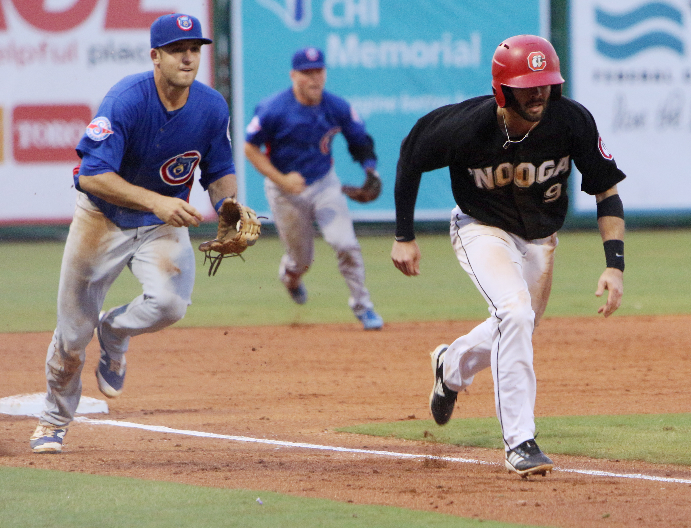 Smokies third baseman Jason Vosler (22) chases after Chattanooga's Levi Michael (9) gets caught in a rundown during the Chattanooga Lookouts' game against the Tennessee Smokies Wednesday, July 5, 2017, in Southern League baseball at AT&T Field in Chattanooga, Tenn.