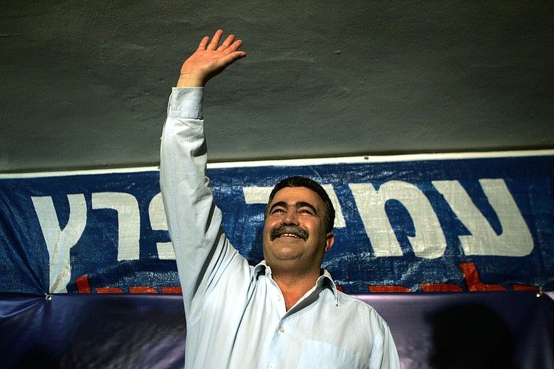 
              FILE -- In this May 29, 2007 file photo, former Israeli Defense Minister and Labor Party chairman Amir Peretz waves to his supporters in Rishon Letzion near Tel Aviv, Israel. As Israel’s Labor Party prepares to choose its new leader, it has already taken a big step toward shedding its image as a bastion of liberal, upper-class Israelis of European descent. A party primary on Tuesday chose two politicians of Moroccan heritage as finalists for next week’s runoff, handily defeating a trio of established blue-bloods associated with the old guard. (AP Photo/Ariel Schalit, File)
            