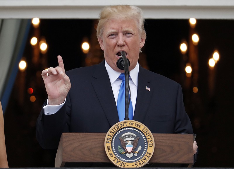 
              President Donald Trump speaks from the Truman Balcony at the Fourth of July picnic for military families on the South Lawn of the White House, Tuesday, July 4, 2017, in Washington. (AP Photo/Alex Brandon)
            