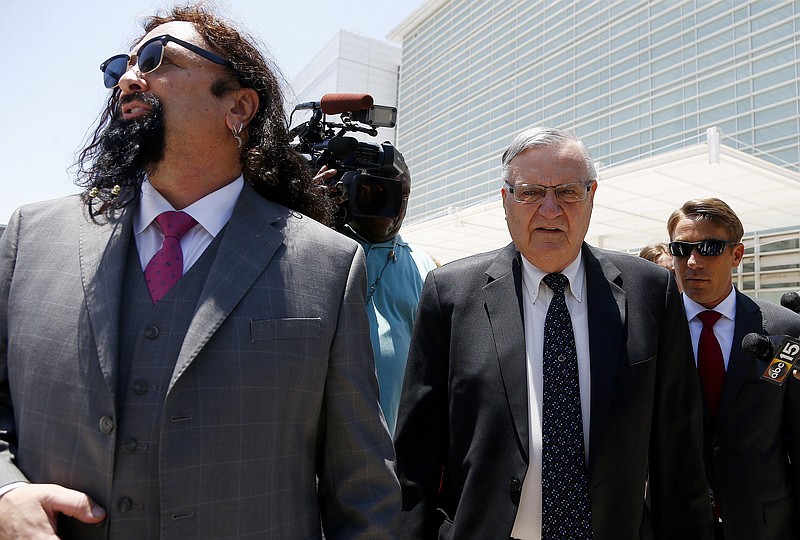 
              FILE - In this June 26, 2017, file photo, former Maricopa County Sheriff Joe Arpaio, second from right, leaves U.S. District Court on the first day of his contempt-of-court trial with attorney Mark Goldman, left, in Phoenix. Lawyers are scheduled to make closing arguments Thursday, July 6 at the criminal trial of the former six-term sheriff of metro Phoenix. Arpaio is charged with misdemeanor contempt-of-court for defying a judge's order to stop his traffic patrols that targeted immigrants. (AP Photo/Ross D. Franklin, File)
            