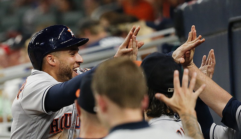 Houston Astros' George Springer (4) celebrates after scoring on a two-run double by Josh Reddick in the fifth inning of a baseball game Wednesday, July 5, 2017, in Atlanta. (AP Photo/John Bazemore)