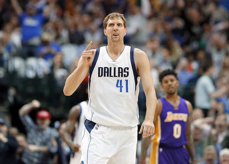 
              FILE- In this March 7, 2017, file photo, Dallas Mavericks forward Dirk Nowitzki, of Germany, celebrates sinking a three-point basket early in the first quarter of an NBA basketball game against the Los Angeles Lakers in Dallas. A person with knowledge of the agreement says the Dallas Mavericks and Dirk Nowitzki have agreed on a two-year, $10 million deal that assures a 20th season for the star forward.  The second year of the contract carries a team option, the person told The Associated Press, Thursday, July 6, 2017, on condition of anonymity because the team hasn't announced the deal. The 39-year-old Nowitzki is set to join Kobe Bryant of the Lakers as the only players to spend 20 seasons with one franchise.
 (AP Photo/Tony Gutierrez, File)
            