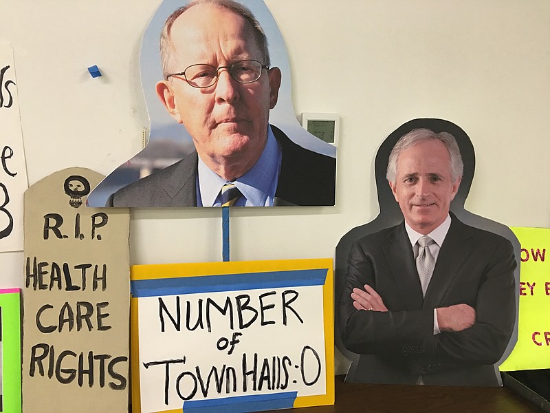 Senators Lamar Alexander and Bob Corker did not attend a Alliance for Healthcare Security town hall meeting at the Chattanooga Public Library, but organizers presented plenty of images of the two elected officials.