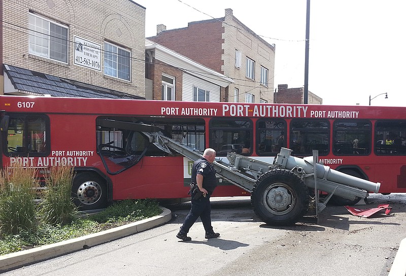 
              A Port Authority bus that hopped a curb and crashed into a war memorial cannon came to a rest against a wall Saturday, July 8, 2017, in the Brookline neighborhood of Pittsburgh. Spokesman Jim Ritchie of the Port Authority of Allegheny County says no bus passengers were injured in the Saturday afternoon accident in the Brookline neighborhood. (Anthony Conroy/Pittsburgh Post-Gazette via AP)
            