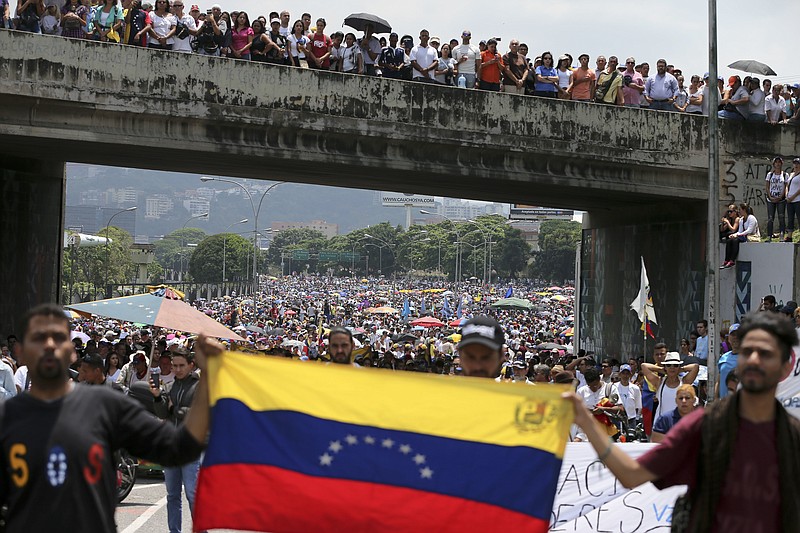 
              FILE - In this April 24, 2017 file photo, anti-government protesters block a highway in Caracas, Venezuela. The opposition's recent wave of protests of near-daily demonstrations hit the symbolic mark of 100 days on Sunday, July 9, 2017. (AP Photo/Fernando Llano, File)
            