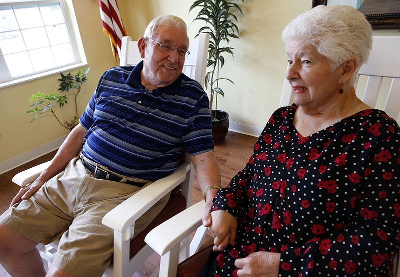 
              Chuck Schwarz, left, holds hand with his wife Cathy at Heritage Woods of South Elgin, Friday, June 30, 2017, in South Elgin, Ill. Medicaid Americans 65 and order and the disabled make up about a quarter of Medicaid recipients but account for two-thirds of its expenditures. (AP Photo/Nam Y. Huh)
            
