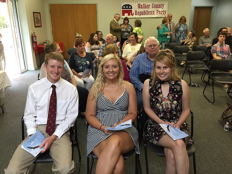 Matthew Ingram, Alexandra Link and Augusta Stone, from left, accept their scholarships during an awards ceremony late last month.