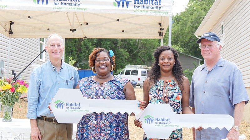 Habitat for Humanity of Greater Chattanooga Area officials Don McDowell, left, and David Butler stand with new homeowners Fanetta McCain, left, and Ashley Jackson. Jackson was the recipient of the first Women Build home built in Chattanooga in 10 years. (Contributed photo)
