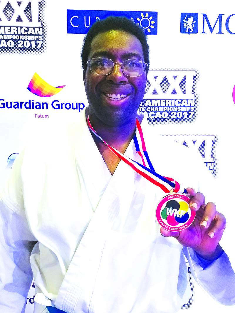 Brainerd resident Ryan Rogers holds up his silver medal after placing second at the Panamerican Karate Federation Championship. (Contributed Photo)