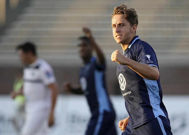 Chattanooga FC midfielder Leo De Smedt (23) fist pumps after scoring a penalty goal during stoppage time of the first half during a play-in match for the NPSL Southeast Conference semifinals at Finley Stadium on Tuesday, July 11, in Chattanooga, Tenn.