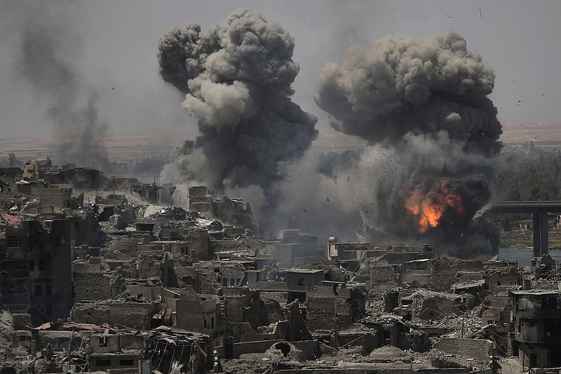 
              Airstrikes target Islamic State positions on the edge of the Old City a day after Iraq's prime minister declared "total victory" in Mosul, Iraq, Tuesday, July 11, 2017. (AP Photo/Felipe Dana)
            