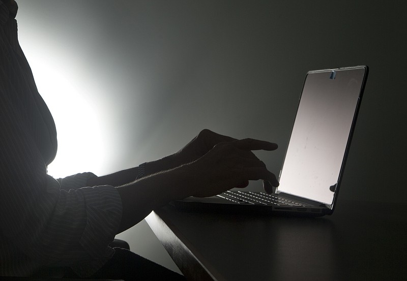 
              FILE - In this, Monday, Dec. 12, 2016, file photo illustration, a person types on a laptop, in Miami. A new Pew Research Center study says a whopping 41 percent of U.S. adults have experienced online harassment, ranging from offensive name-calling to stalking and sexual harassment. (AP Photo/Wilfredo Lee)
            