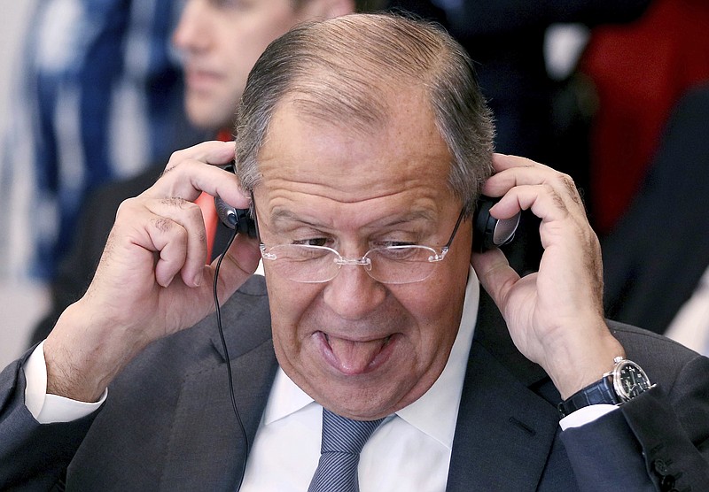 
              Russian Foreign Minister Sergey Lavrov adjusts his ear phone during an informal ministerial meeting of the Organization for Security and Cooperation in Europe, OSCE, in Mauerbach near Vienna, Austria, Tuesday, July 11, 2017. (AP Photo/Ronald Zak)
            
