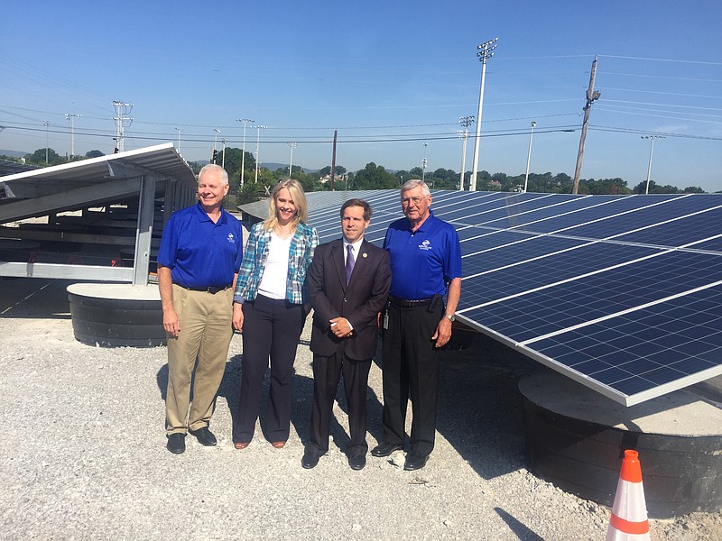 EPB president David Wade, TVA Director of Business Development and Renewables Tammy Bramlett, U.S. Rep. Chuck Fleischmann, R-Tenn., and EPB Chairman Joe Ferguson stand in front of new solar generation facility at Oak and Greenwood in Chattanooga.