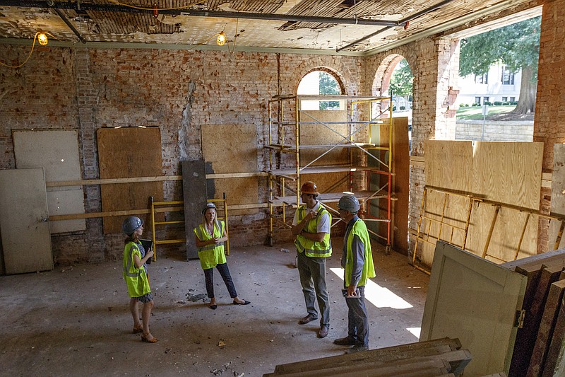 People walk through construction in the Mayfield Annex on Tuesday, July 11, 2017, in Chattanooga, Tenn.
