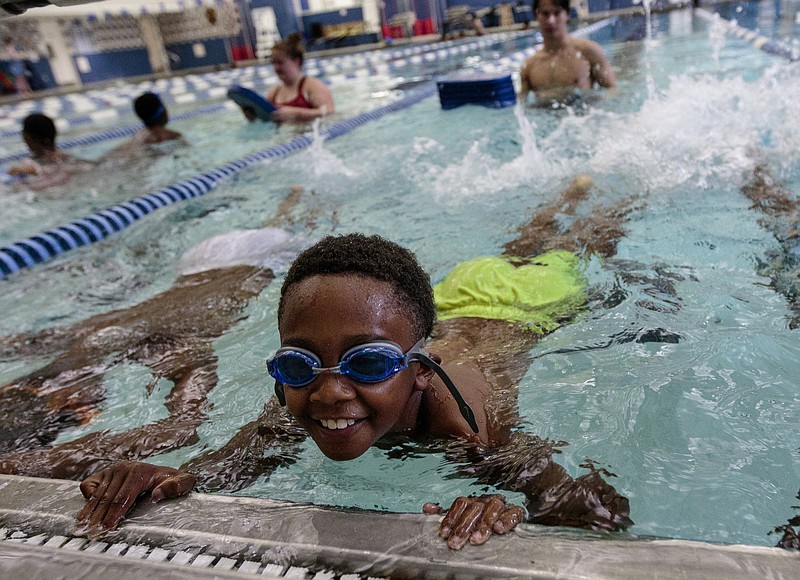 Khristian Martin practices kicking during a swim period at McCallie School's Bridge Scholars summer program on Wednesday, July 12, 2017, in Chattanooga, Tenn. The program gives students in underserved communities new learning experiences.
