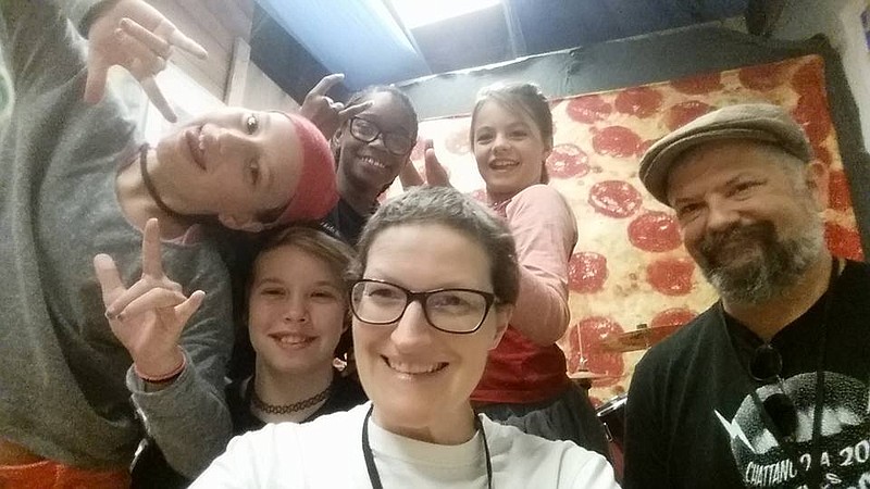 Campers from last year's Chattanooga Girls Rock Camp surround volunteer Amy Nelson.