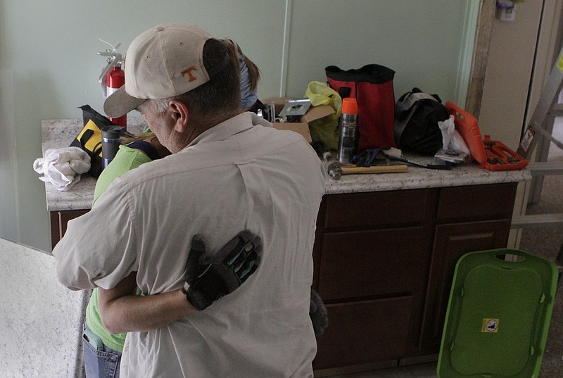 Connie, left, and Michael Arnold hug each other after taking a break to talk to the Times Free Press while working inside one of the housing buildings at Blazing Hope Ranch on Monday, June 26, in Rhea County, Tenn. Connie is on the Blazing Hope board.