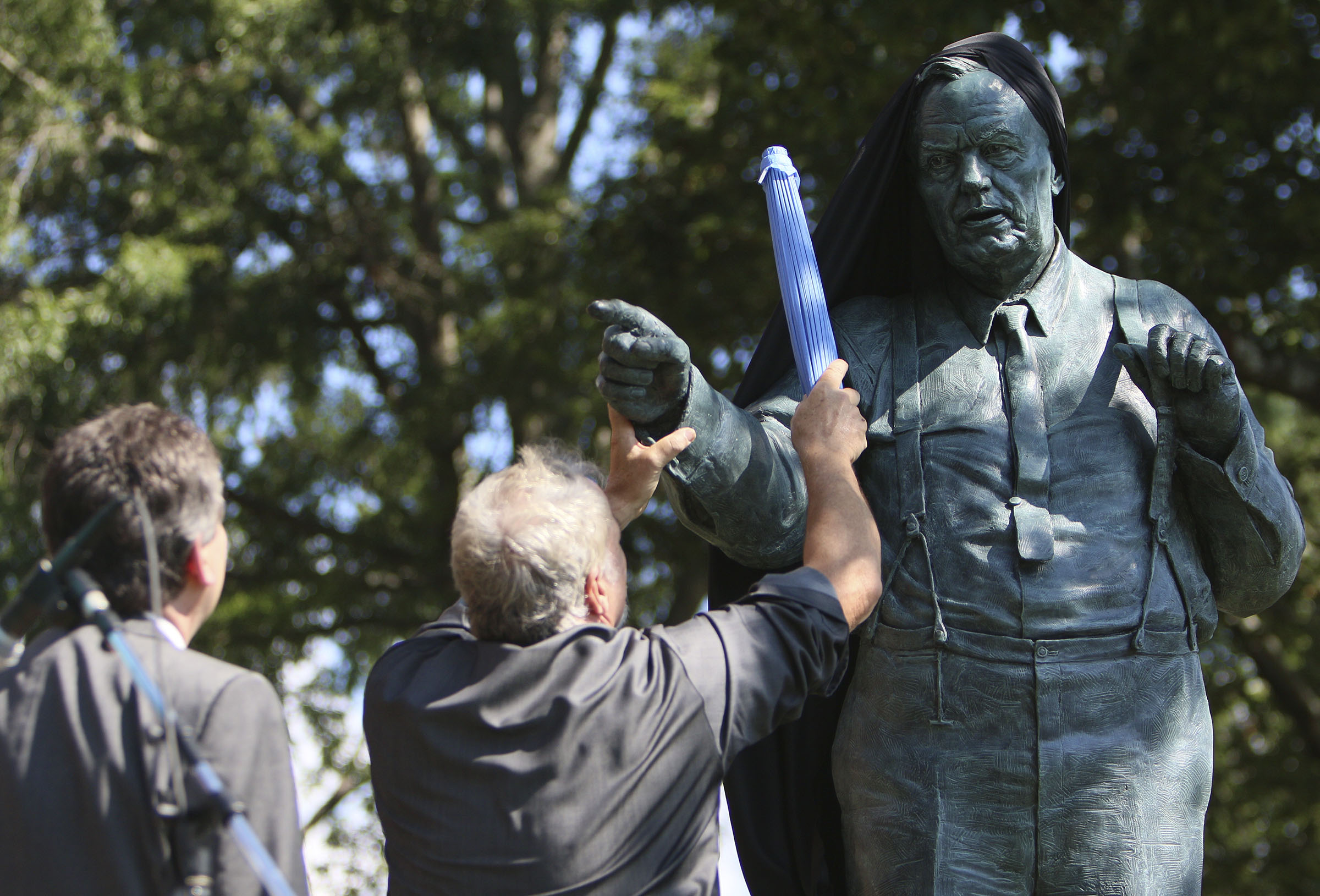 Zenos Frudakis, the artist of the sculpture, and John de Lance, an actor, help unveil the Clarence Darrow Commemorative Statue Friday, July 14, 2017, at the Rhea County Courthouse in Dayton, Tennessee. William Jennings Bryan was honored by a statue being commissioned by Bryan College and created by Cessna Decosimo in 2005 for the Rhea County Courthouse, and Friday a statue was unveiled for Clarence Darrow.