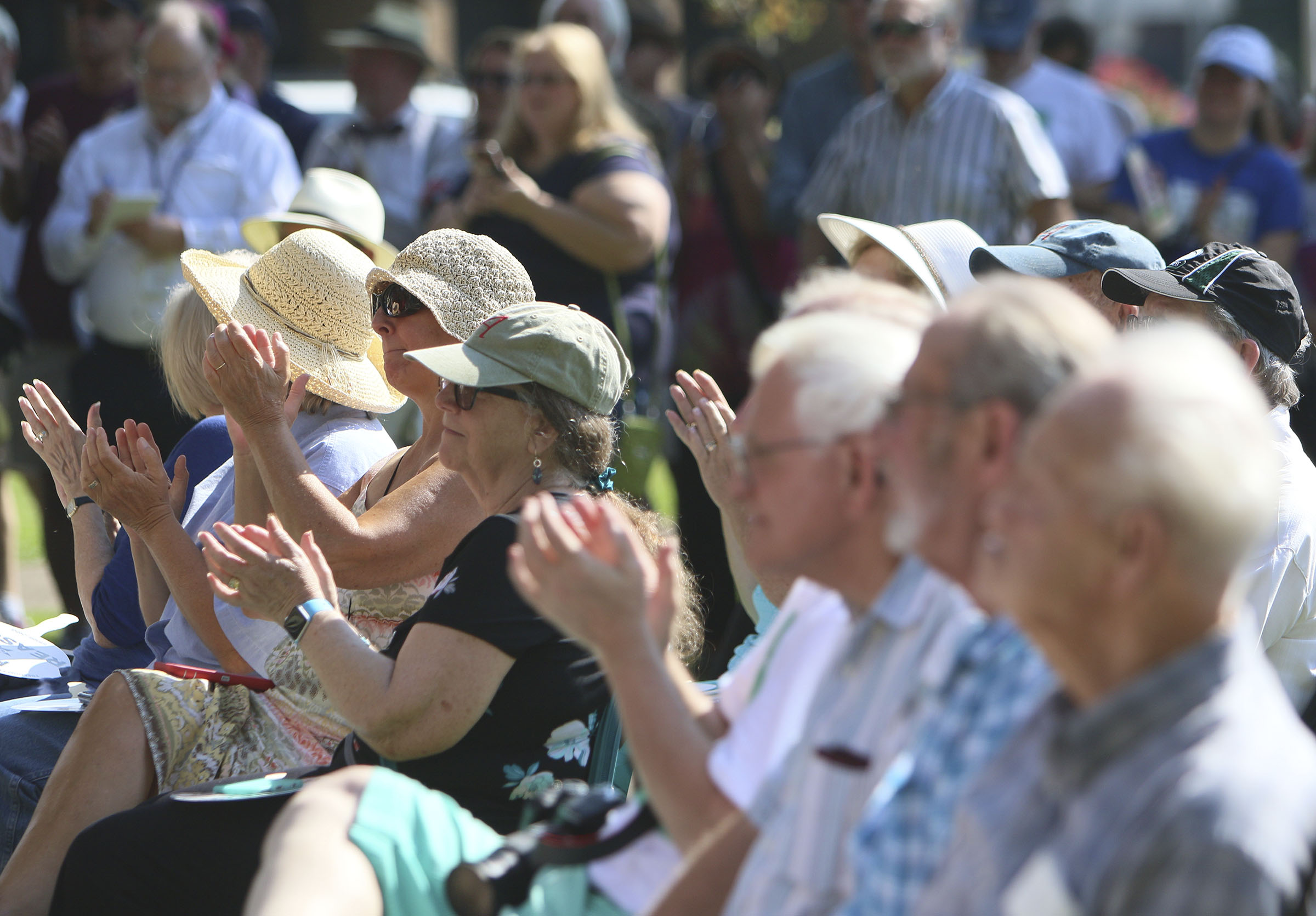 Attendees of the dedication and unveiling event of the Clarence Darrow Commemorative Statue clap as different speakers talk during the event Friday, July 14, 2017, at the Rhea County Courthouse in Dayton, Tenn. William Jennings Bryan was honored by a statue being commissioned by Bryan College and created by Cessna Decosimo in 2005 for the Rhea County Courthouse, and Friday a statue was unveiled for Clarence Darrow.
