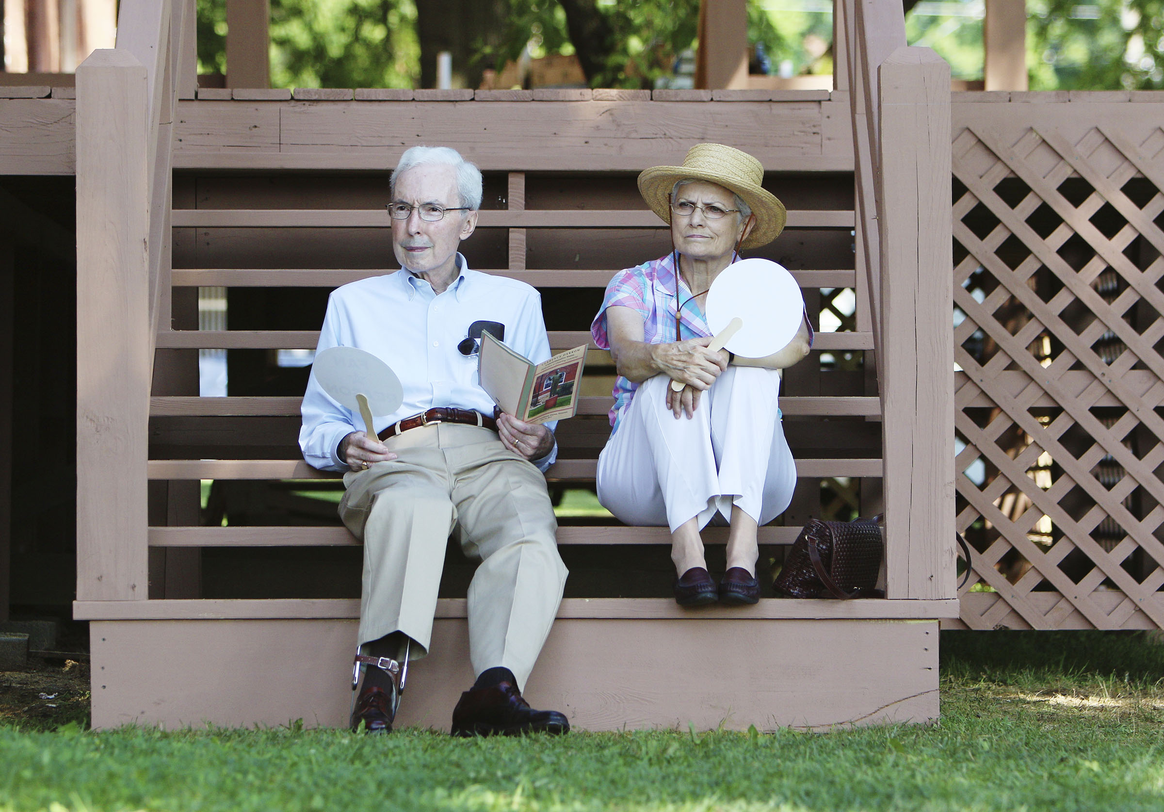 Dan and Sylvia MacNeill of Dayton, Tenn., listen to presentations for a shady spot during the dedication and unveiling event of the Clarence Darrow Commemorative Statue Friday, July 14, 2017, at the Rhea County Courthouse in Dayton, Tenn. Sylvia's father was a boy living in Dayton when the trial was happening.