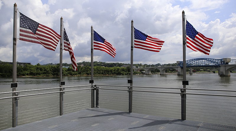 American flags, one for each of the Fallen Five, are seen at the end of the pier at Ross's Landing on Monday, July 3, in Chattanooga, Tenn.